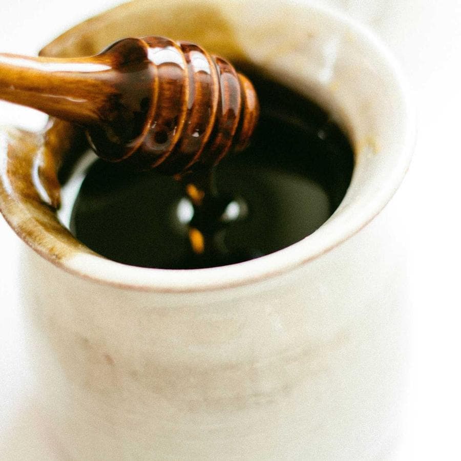 Honey poured into a cup