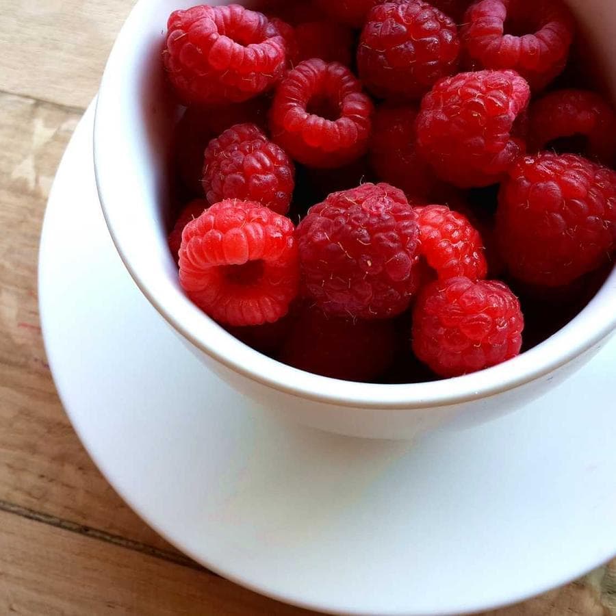 Raspberries in a white bowl