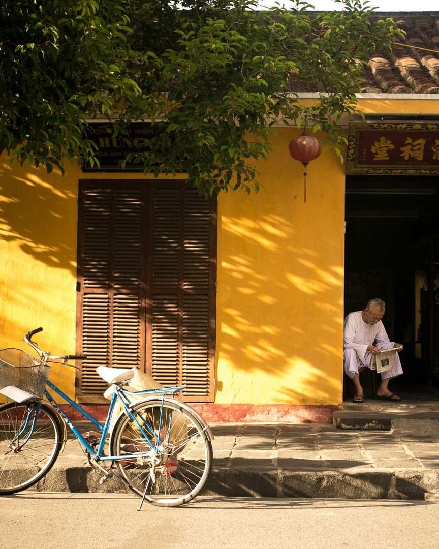 A yellow shopfront with a bicycle